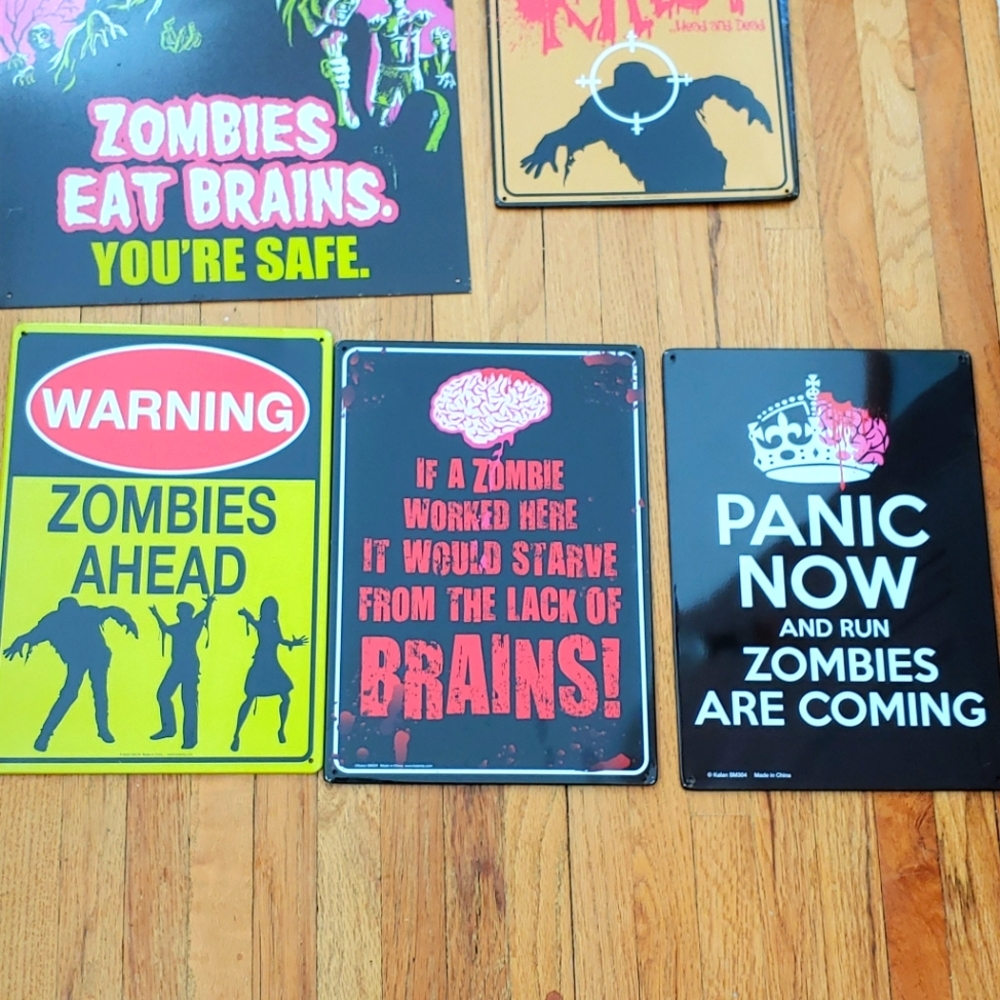 Six metal zombie signs.